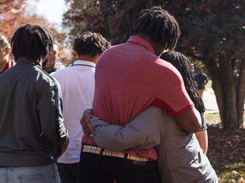 Students console each other following Omari Alexander memorial service