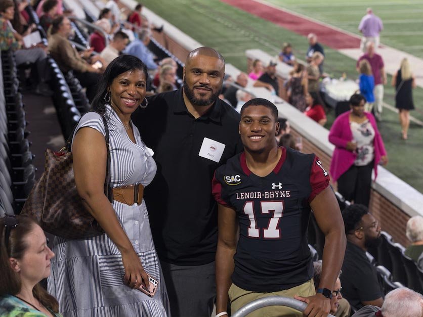 Supporters and LR football player in the stands