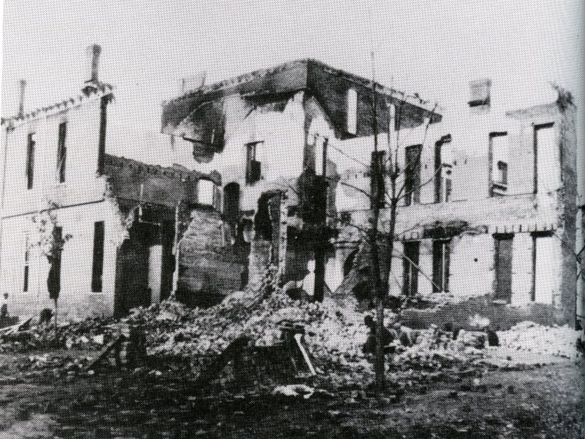 A black and white archive photo of a campus building in the 1900s