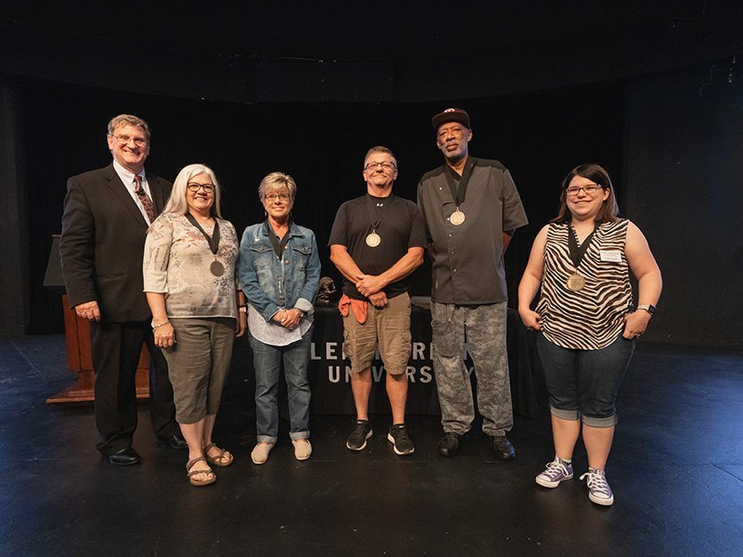 Staff receiving award from President Fred Whitt