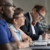 Three LTSS students listening to professor in a classroom