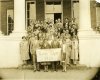 A group of people stand together in an archived 1926 photo