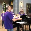 Choir director Ryan Luhr leads a practice with young summer camp singers.