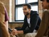 Person receiving trauma counseling in group setting in office