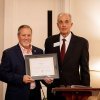 John Love receives his alumni award from Andy Anderson