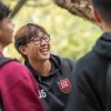 Three students talking on campus between classes