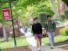 Two students walking to class along campus sidewalk
