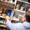 Pastor Todd Cutter places stock on a shelf in the current food pantry