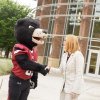 Summer McGee and Joe Bear shake hands in front of George Hall