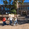 Three students walking out of Rhyne Building between classes