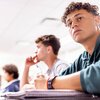 Students listening to professor in classroom