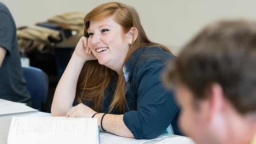 A student smiling in the classroom