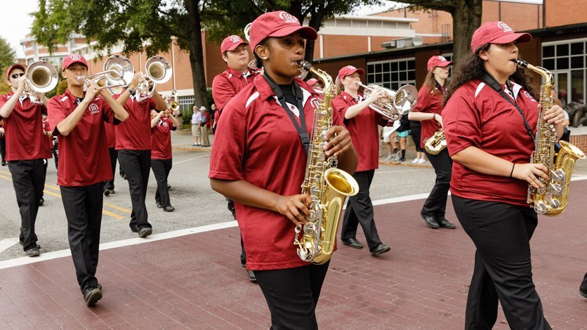 Marching band students playing in Homecoming Parade