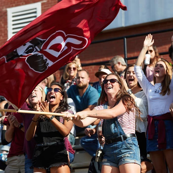 Students cheering LR football in stands