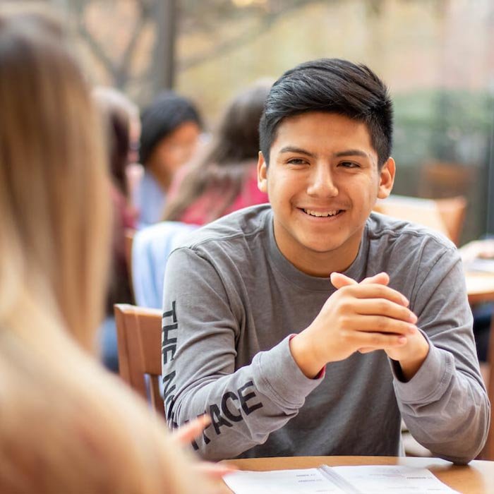 Students talking at table in coffee shop