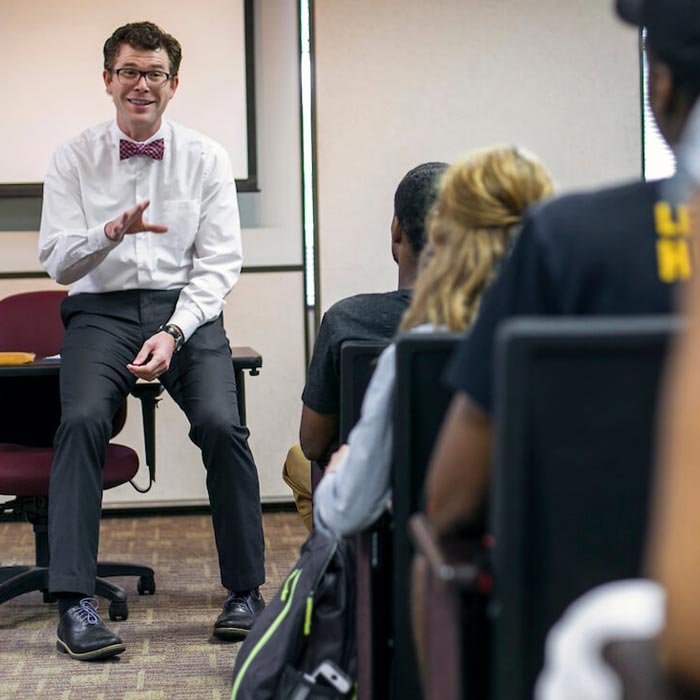 Professor talking to students from front of classroom