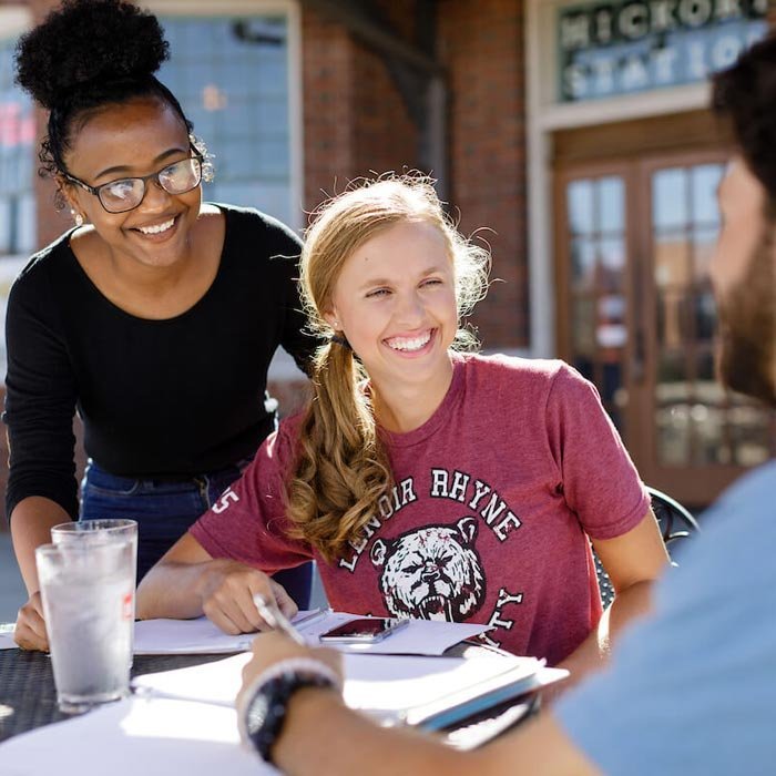 Three students studying at table at Hickory Station in City of Hickory