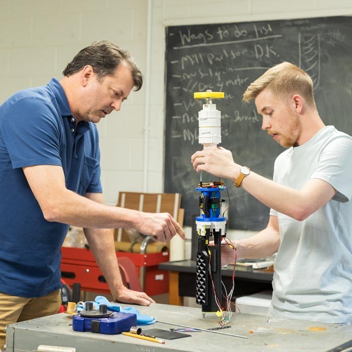 Professor and student work on project in lab